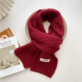 Deep red cable-knit scarf with YYDS fabric label laid on aesthetic white tray - Burgundy