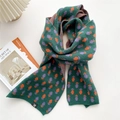 Green knitted scarf featuring purple floral patterns and a small black 'H' patch label - Purple Orange Floral Green (MX0175)