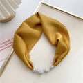Close-up of yellow satin neck scarf with silver magnetic crystal ball pendants - Yellow