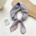 Elegant lavender square silk scarf with contrast pink hem tied for a chic fashion look - Gray