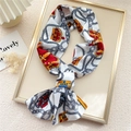 Narrow polyester scarf with crown and chain print styled in a decorative tray - White Gold Crown Chain