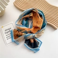 Lightweight floral print silk scarf in vibrant orange and sky blue abstract design - Fallen Leaves