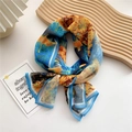 Artistic abstract print silk scarf with blue edges on an elegant wooden tray - Flying Bird