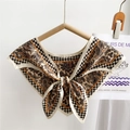 Champagne paisley and houndstooth silk scarf tied in a bow on a wooden hanger - Paisley Geometric Gold