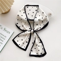 Elegant black and white floral silk scarf tied in a bow with minimalist clover pattern - 16X Four-Petal Flower Black