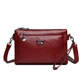 Minimalist dark red leather crossbody bag with bow hardware and textured finish - Red