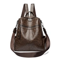 Vintage brown leather backpack with multiple zipper compartments and metal buckle accents - Brown