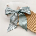 Mint green satin hair ribbon with blue floral print displayed on a wooden tray - Thin Branches (2X)
