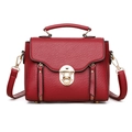 Retro burgundy leather handbag with gold twist lock and crossbody strap on white background - Red