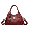 Dark red lychee pattern leather handbag with double handles and leaf pendant accessory - Red