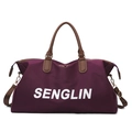Large dark purple travel bag with brown faux leather handles and adjustable shoulder strap - Purple