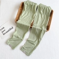 Detailed macro view of thin ice silk arm sleeves featuring a delicate brand hem label - One Size / Green