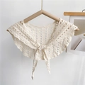 Close-up of cream crochet hollow shawl with geometric patterns and front tie bow detail - Cream