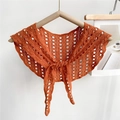 Detail of orange-red knitted lace capelet with hollow circular pattern and front tie - Orange