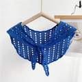 Close-up of Klein blue hollow crochet knit shawl with elegant front bow tie detail - Blue