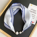 Close-up of silk scarf necklace with blue geometric patterns and luxury rhinestone buckle - Deep Blue Braided Chain
