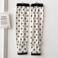 Close-up of off-white sun protection cooling sleeves with black B-letter pattern print - Letter B Black and White All-over Print