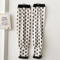 Detail of white cooling arm sleeves with black letter C pattern and elastic cuffs - Letter C Black and White Print