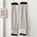 Close-up of summer cooling sun protection sleeves with stylish black S-pattern print - Letter H Black and White Print