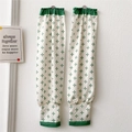 Detail of white cooling arm sleeves with green floral pattern and elastic cuffs - Cross Snowflake Green Print