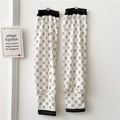 Detail of white ice silk sun sleeves with black monogram pattern and elastic cuffs - Outlined C Black and White All-over Print