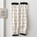 Detail of off-white cooling arm sleeves with black FEAR OF LEADER letter print and elastic cuffs - FEAR OF LEADER Letter Print