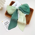 Gradient green pleated silk scarf tied in a bow knot inside a woven basket - Gradient Deep Green