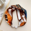 Detail of silk scarf choker with horse print pattern and sparkling rhinestone magnetic buckle - Caramel Orange Equestrian Horse