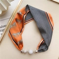 Detail of silk neck scarf with horse print, wavy patterns and sparkling diamond charms - Orange Wave Pattern Horse