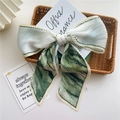 Pleated light teal striped scarf tied in a bow on a vintage woven tray decoration - 9 Pleated Green Scenery