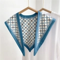 Sky blue triangle silk scarf with geometric ring patterns and dark blue hemline - Triangular Clover