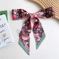 Pink and navy peony floral print twilly silk scarf tied in a bow on a stylish wooden tray - 125cmx7cm / Fire Red Lotus