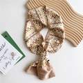 Narrow silk scarf with champagne geometric pattern displayed on minimalist background - Khaki Pixel Geometric