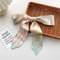 Narrow silk twilly with orange lotus and plaid pattern draped on a woven tray - 7x130cm / Silver Lotus Print