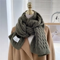 Detailed cable knit texture of dark green winter scarf with brand tag on camel wool coat - Dark Green