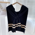 Striped knit shawl in black with beige accents, styled as a layered shoulder wrap - Black