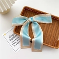 Light blue and cream silk skinny scarf tied in a bow on a woven tray - Blue Beige Contrast