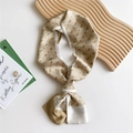 Golden brown geometric silk twilly scarf with arched patterns on a wooden tray - Khaki Crease Line