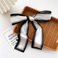 Narrow black and white silk ribbon scarf with Fashion Girl print tied in a bow - White and Black Patchwork