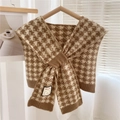 Detail of knitted houndstooth pattern shawl with a minimalist logo tag on ribbed edge - Khaki Houndstooth