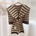 Close-up of knit striped shawl with embroidery patch on soft neutral background - Brown Stripes