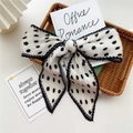 Elegant pleated scarf featuring black polka dots on white fabric with fine black edging - Pleated White Polka Dot