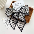 Fashionable black and white houndstooth pleated bow hair accessory in a woven basket - Pleated Black Houndstooth