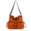Vibrant orange nylon drawstring bucket bag with adjustable black strap and side pockets - Brown