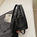 Minimalist black lychee pattern leather bucket handbag with gold rivet details - Black