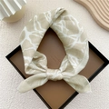 Chic beige cotton linen square scarf with white leaf patterns tied in a stylish loop - Beige Water Flow Pattern