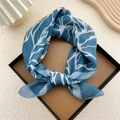 Blue linen-cotton neckerchief with white abstract leaf print tied in a soft bow - Blue Water Flow Pattern