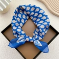 Cotton linen square scarf in blue with orange floral pattern tied in a bow - Blue Peacock Feather Pattern