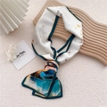 Elegant white silk scarf with green borders and orange bird prints on wooden board - Deer Forest Peak