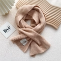 Detail of warm pink ribbed knit scarf featuring a white handmade brand label on texture - One Size / Camel